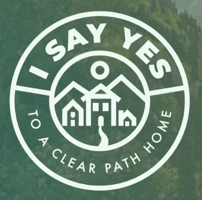 A logo for the I SAY YES Campaign that shows is green and orange gradient in a circle with a house.