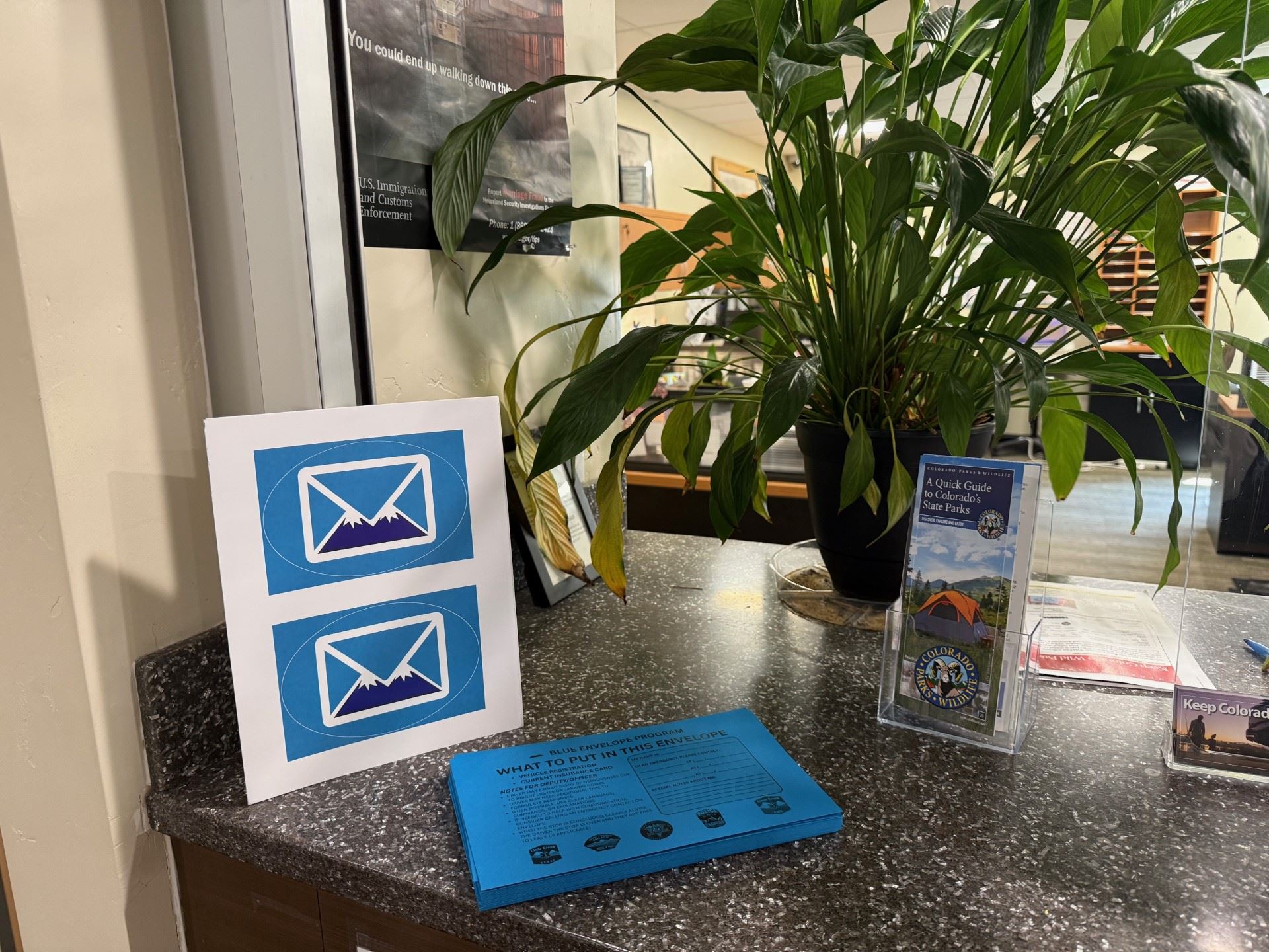 The blue envelope and stickers on display at the Clerk and Recorders Office