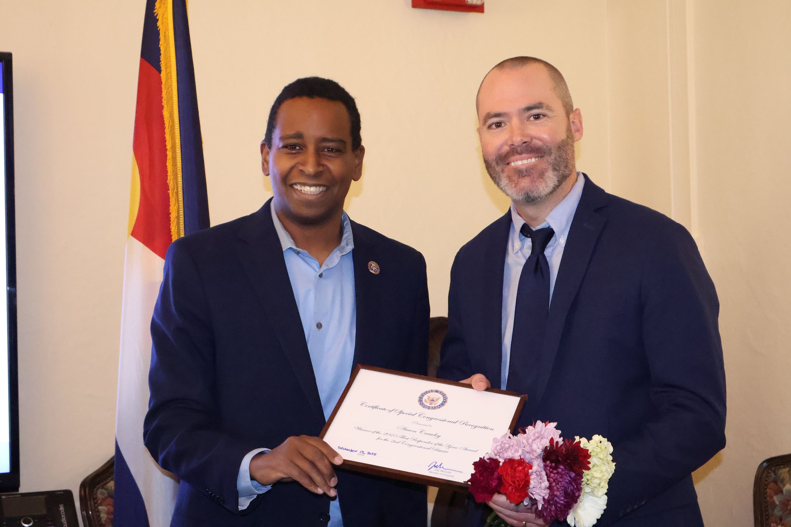 CCEMS Dir. Aaron Crawley poses with Rep. Joe Neguse